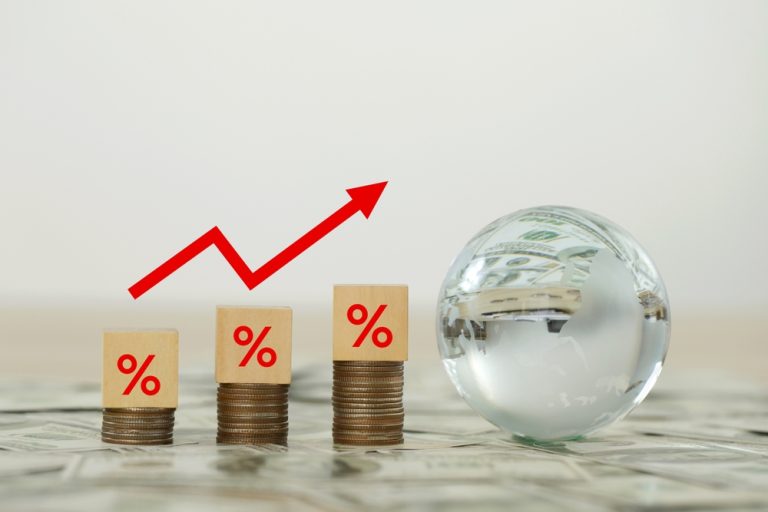 Wooden,Blocks,On,Stack,Coins,With,Percentage,Sign,And,Arrow